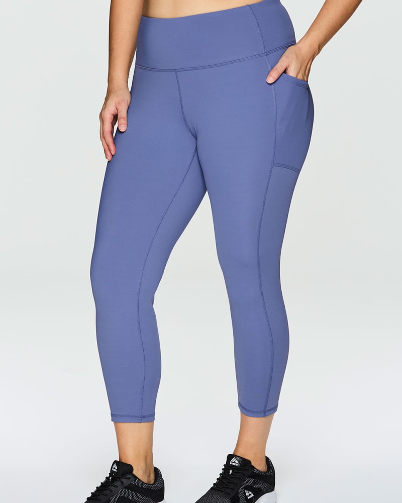 Front of a model wearing a size 1X Prime Tech Flex Ultra Hold Legging in Periwinkle by RBX Active. | dia_product_style_image_id:244629